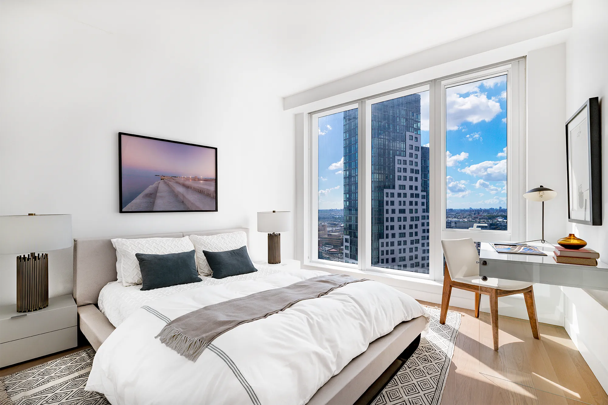 Large modern bedroom with king-size bed and desk with chair